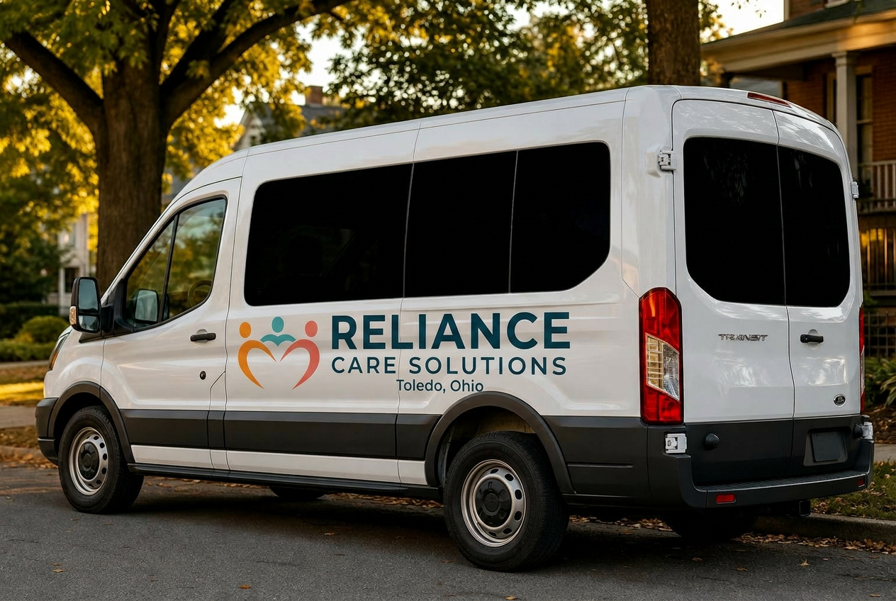 Reliance Care Solutions 15-passenger van with blacked-out windows, parked on a tree-lined Toledo street at golden hour